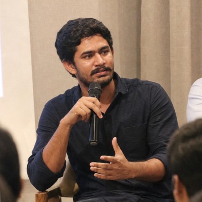 Arun Chandel speaking with a microphone